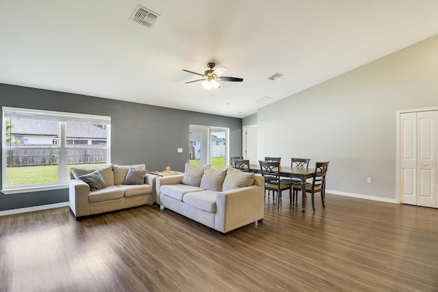 living room featuring dark hardwood / wood-style floors, ceiling fan, and lofted ceiling