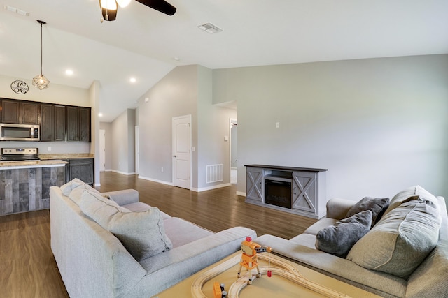 living room with lofted ceiling, ceiling fan, and dark hardwood / wood-style floors