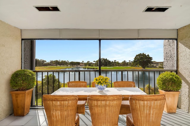 sunroom / solarium with a water view