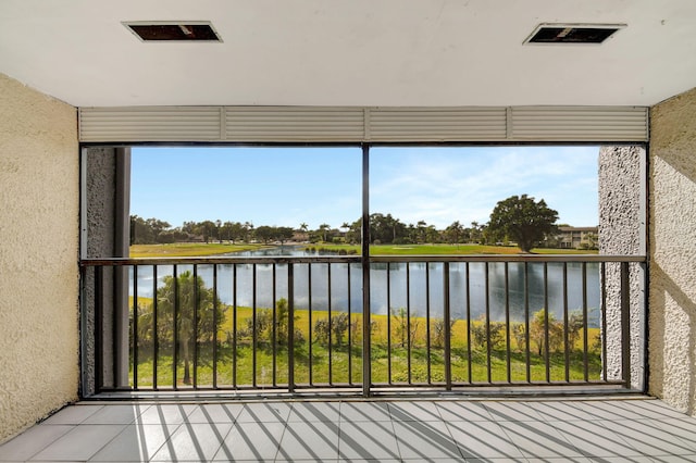 unfurnished sunroom featuring a water view and a healthy amount of sunlight