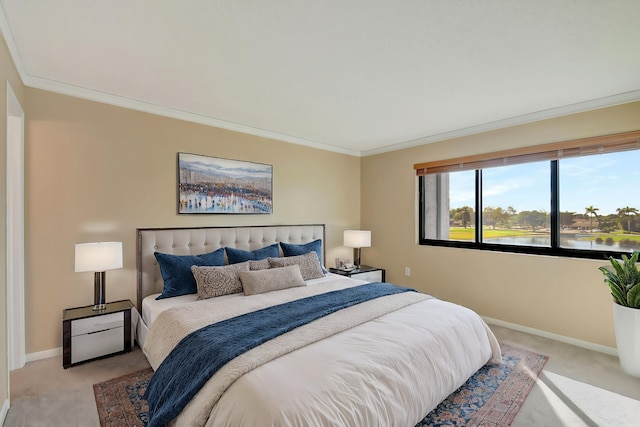 bedroom featuring ornamental molding, a water view, and light carpet