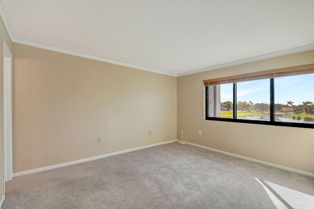 unfurnished room with light colored carpet, ornamental molding, and a water view