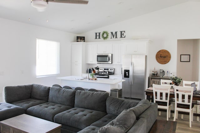 living room featuring dark hardwood / wood-style floors, vaulted ceiling, ceiling fan, and sink