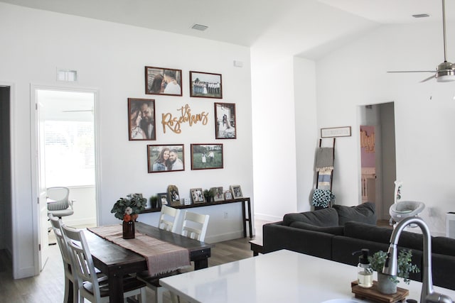 dining area with hardwood / wood-style flooring, ceiling fan, and lofted ceiling