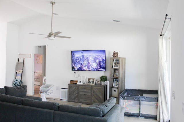 living room featuring ceiling fan and vaulted ceiling