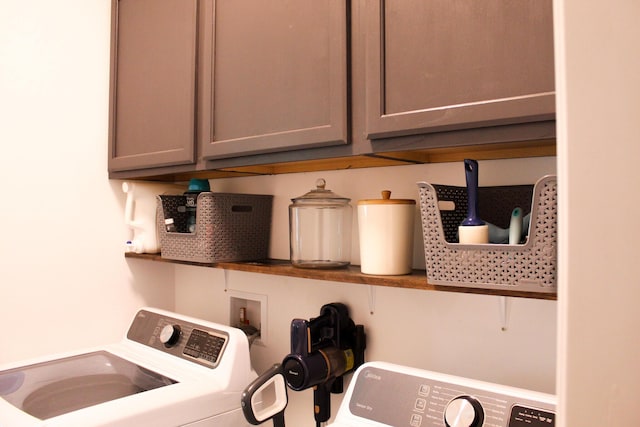 laundry room with washer and dryer and cabinets