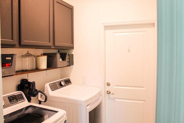 laundry room featuring cabinets and separate washer and dryer