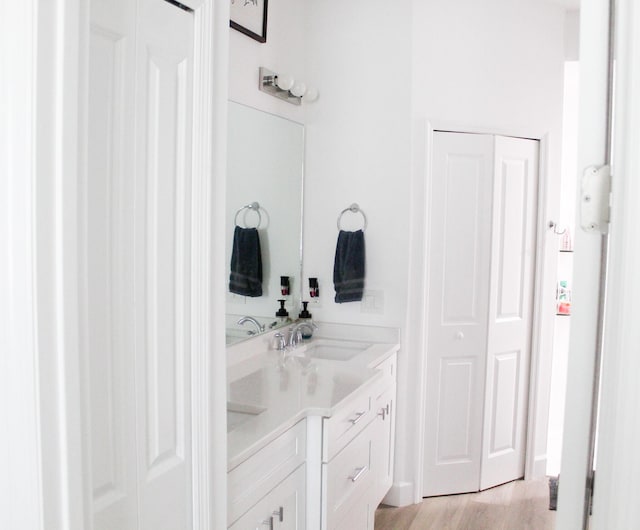 bathroom featuring wood-type flooring and vanity