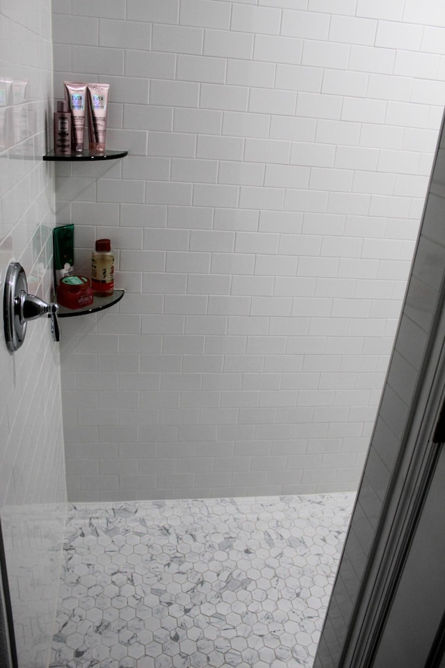 bathroom with tile patterned flooring and walk in shower