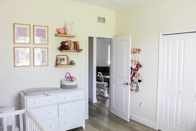 bedroom featuring hardwood / wood-style floors and a closet