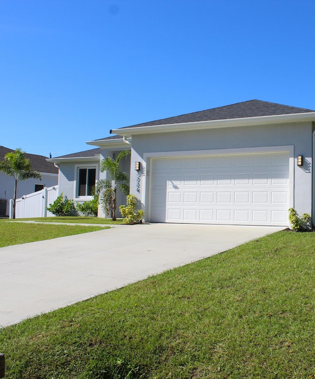 ranch-style house with a garage and a front lawn