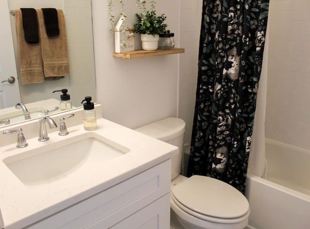 full bathroom with vanity, toilet, and shower / tub combo