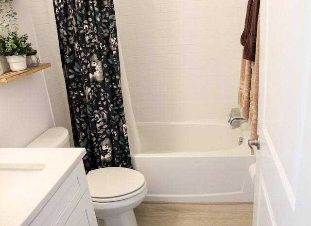 full bathroom featuring vanity, hardwood / wood-style floors, shower / bathtub combination with curtain, and toilet