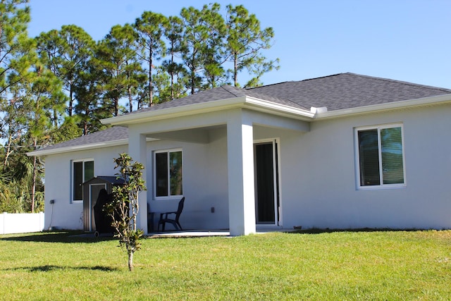 rear view of house featuring a lawn