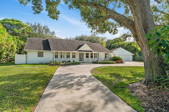 ranch-style home with a front yard, a garage, and covered porch