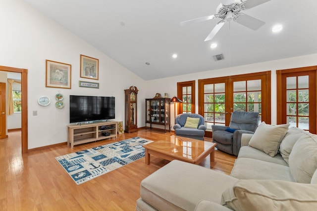 living room with ceiling fan, french doors, lofted ceiling, and light wood-type flooring