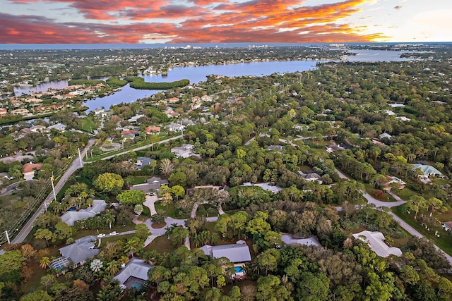 aerial view at dusk with a water view