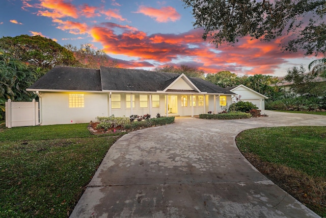 ranch-style home with a yard and a garage