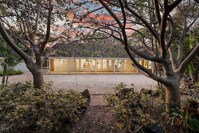 view of back house at dusk