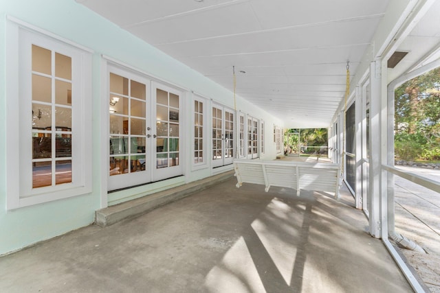 unfurnished sunroom with french doors