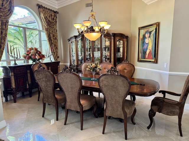 dining area featuring an inviting chandelier and ornamental molding