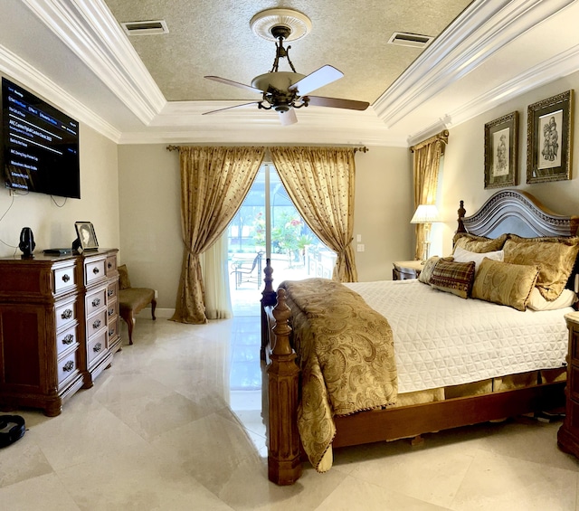 bedroom featuring a tray ceiling, access to exterior, and a textured ceiling