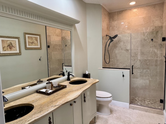 bathroom with vanity, toilet, and a shower with door