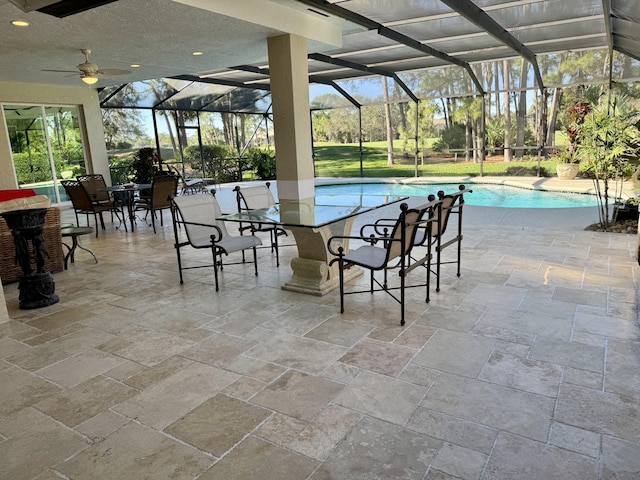 view of swimming pool with a lanai and a patio area