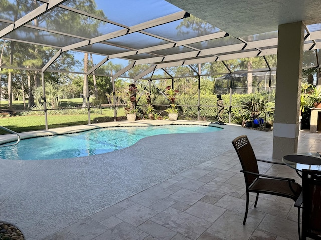 view of swimming pool with a lanai and a patio