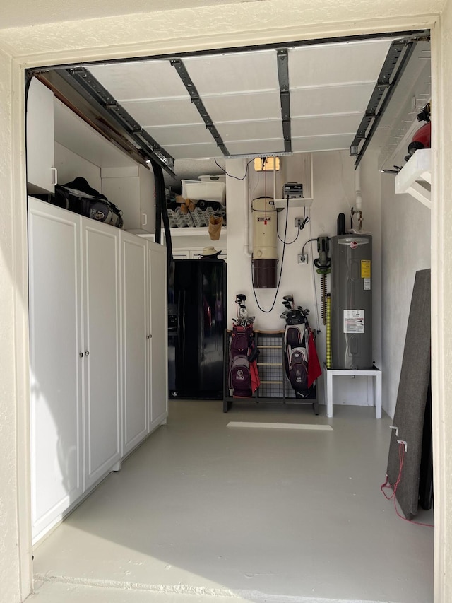 garage with black fridge and electric water heater