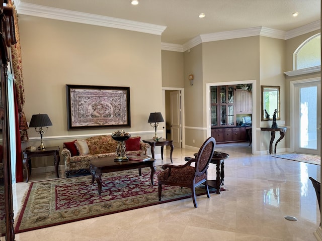 living room featuring crown molding and a towering ceiling