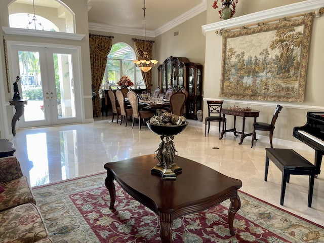 interior space featuring an inviting chandelier, ornamental molding, and french doors