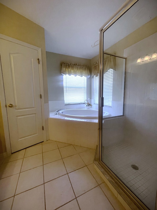 bathroom with tile patterned floors and independent shower and bath