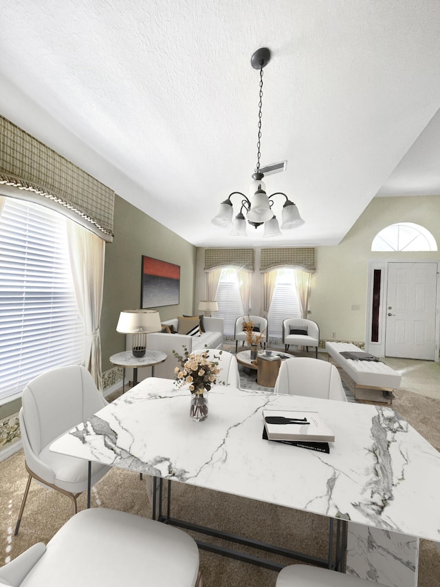 dining space with a notable chandelier, carpet, and a textured ceiling