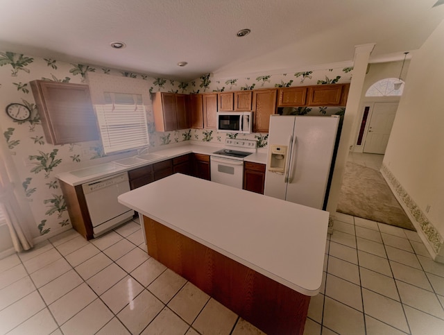 kitchen featuring white appliances, a center island, and light tile patterned floors