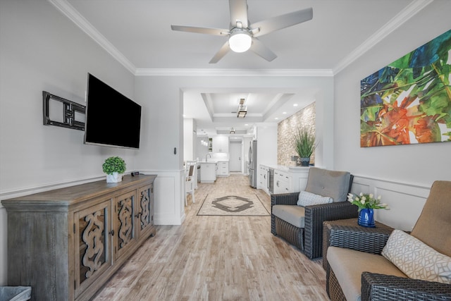 corridor featuring light hardwood / wood-style floors, a raised ceiling, crown molding, and sink