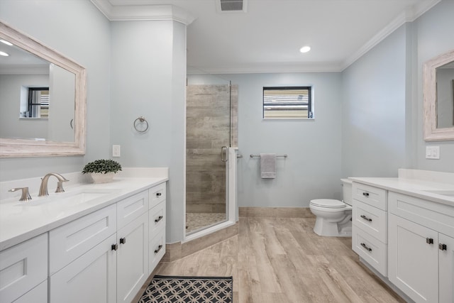 bathroom with wood-type flooring, ornamental molding, walk in shower, and vanity