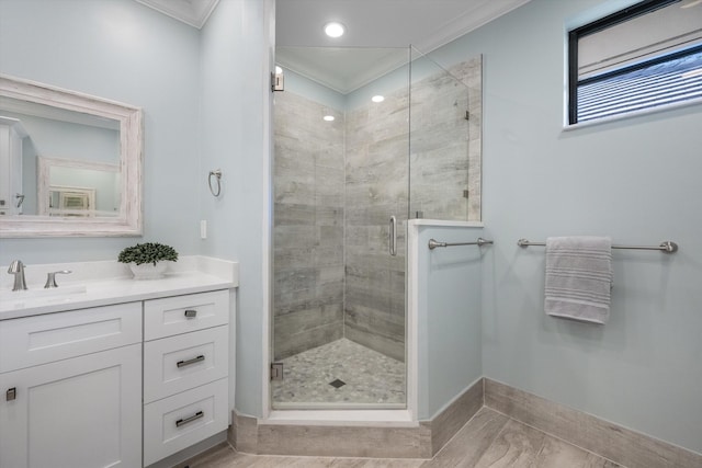 bathroom featuring an enclosed shower, ornamental molding, and vanity