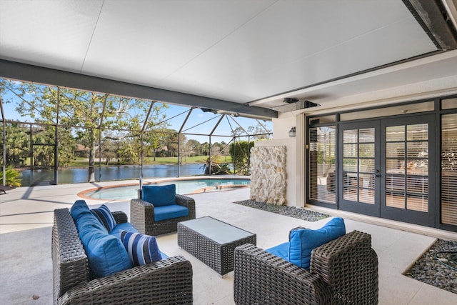 view of patio / terrace with french doors, glass enclosure, outdoor lounge area, and a water view