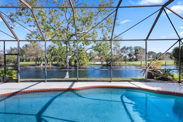 view of swimming pool featuring glass enclosure and a water view