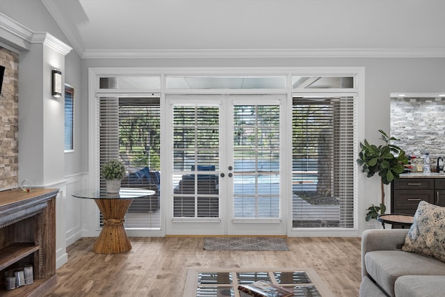 entryway featuring ornamental molding, a wealth of natural light, and hardwood / wood-style flooring