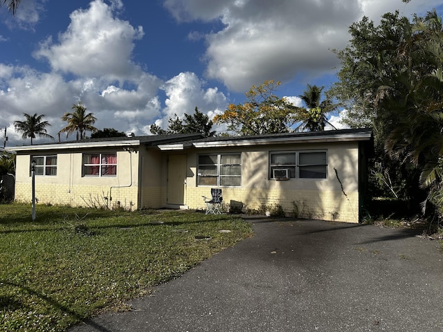 view of front of house with cooling unit and a front yard