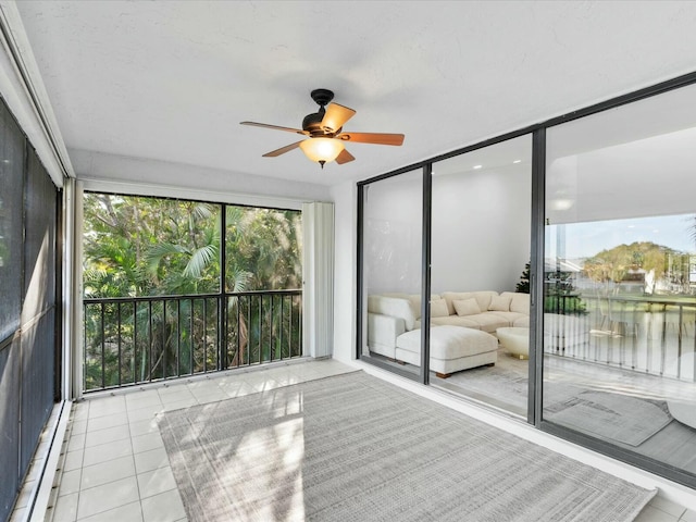 unfurnished sunroom with ceiling fan