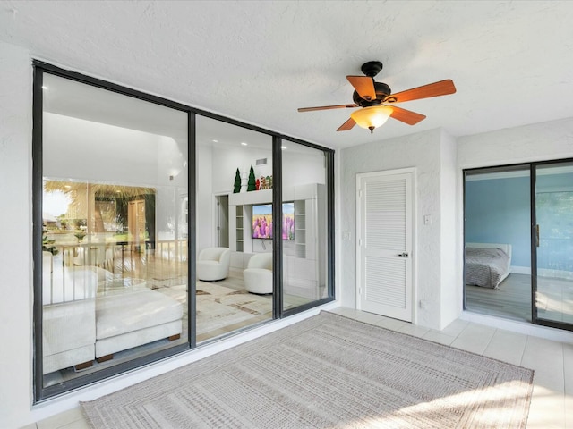 interior space with access to outside, multiple windows, a closet, and light tile patterned flooring