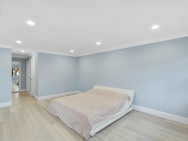 bedroom with crown molding and light hardwood / wood-style flooring