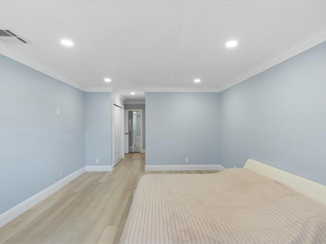 unfurnished bedroom with a closet, crown molding, and light hardwood / wood-style flooring