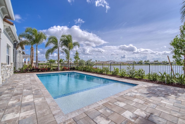 view of swimming pool featuring a patio area and a water view