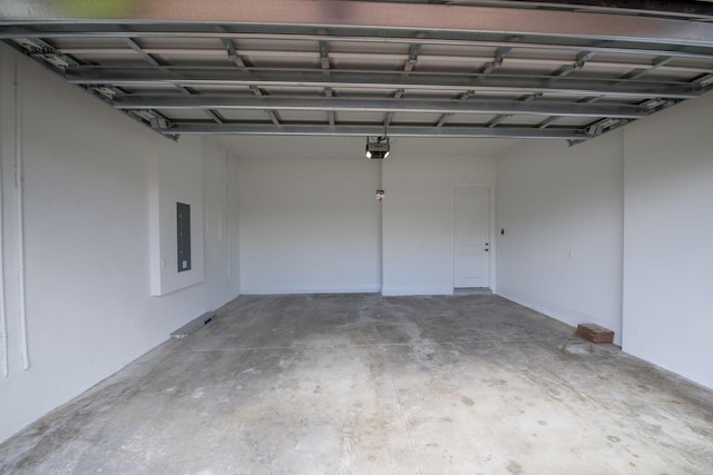 garage with electric panel and a garage door opener