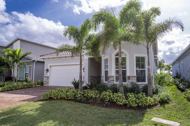 view of front facade featuring a front yard and a garage