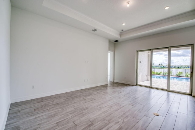 spare room featuring a tray ceiling